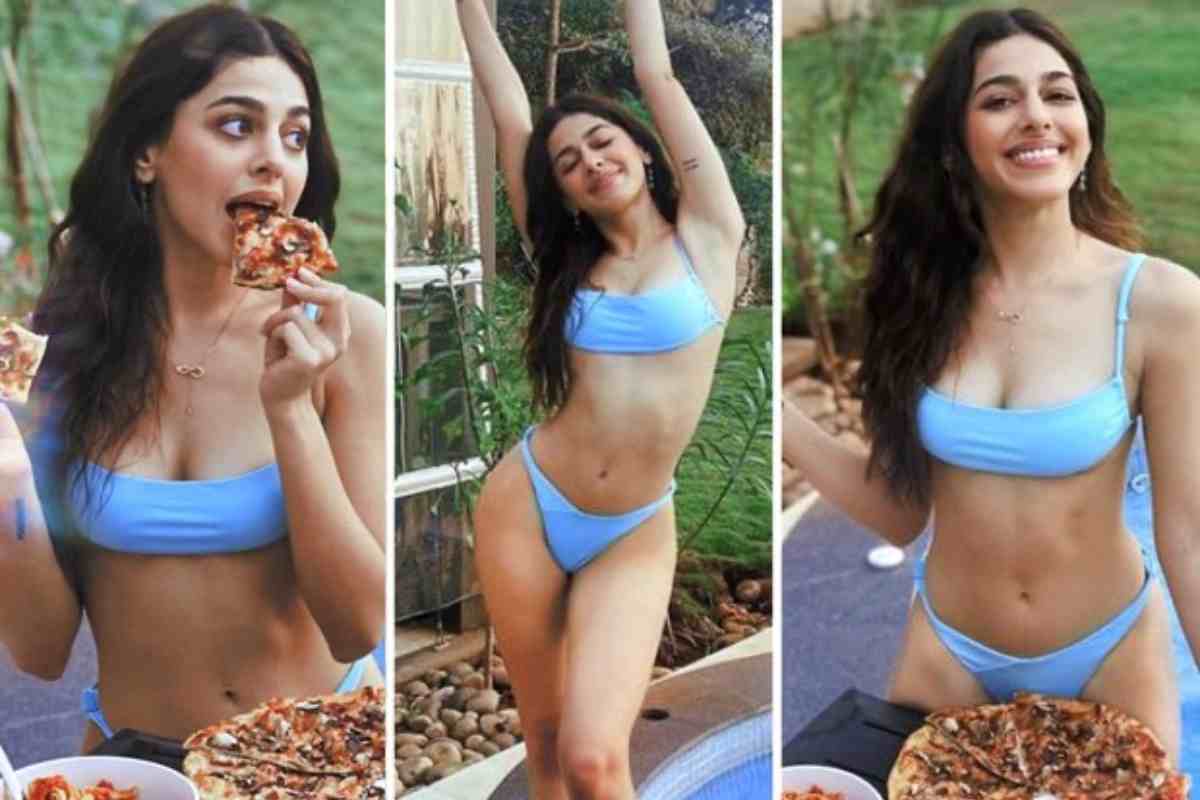 Donna in bikini con pizza